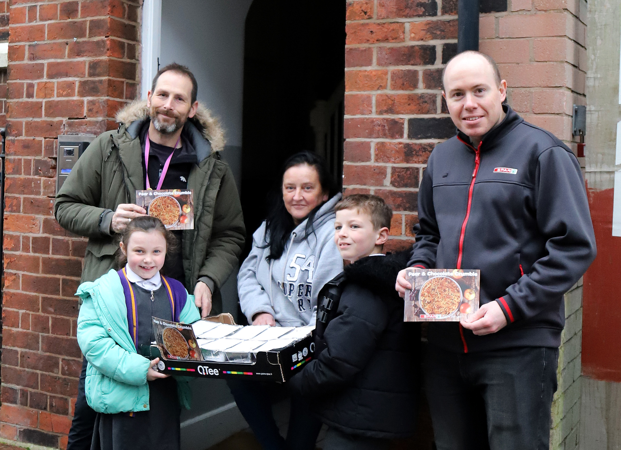 Ashton Primary School and SPAR hand over pear and chocolate crumbles to Foxton Homeless Day Centre