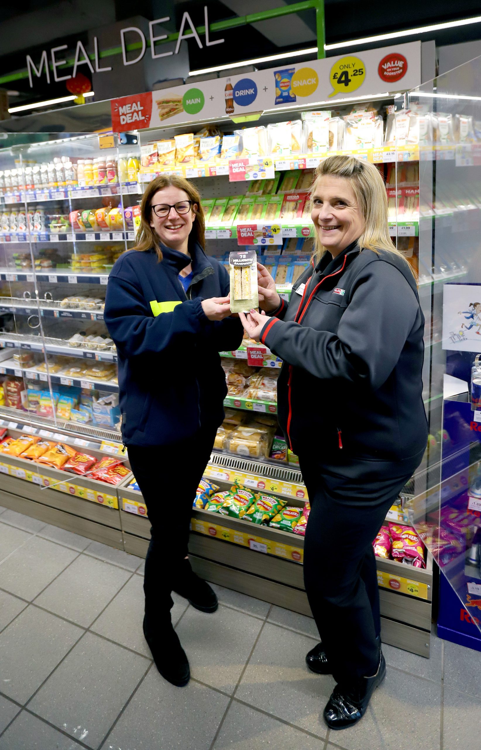 Sally Sneddon, Food To Go Trading Manager at James Hall & Co. Ltd, and Maxine Dover, Store Manager at SPAR Lancaster University, with the 75 millionth sandwich manufactured by the Great Northern Sandwich Company part of the James Hall Group of Companies.