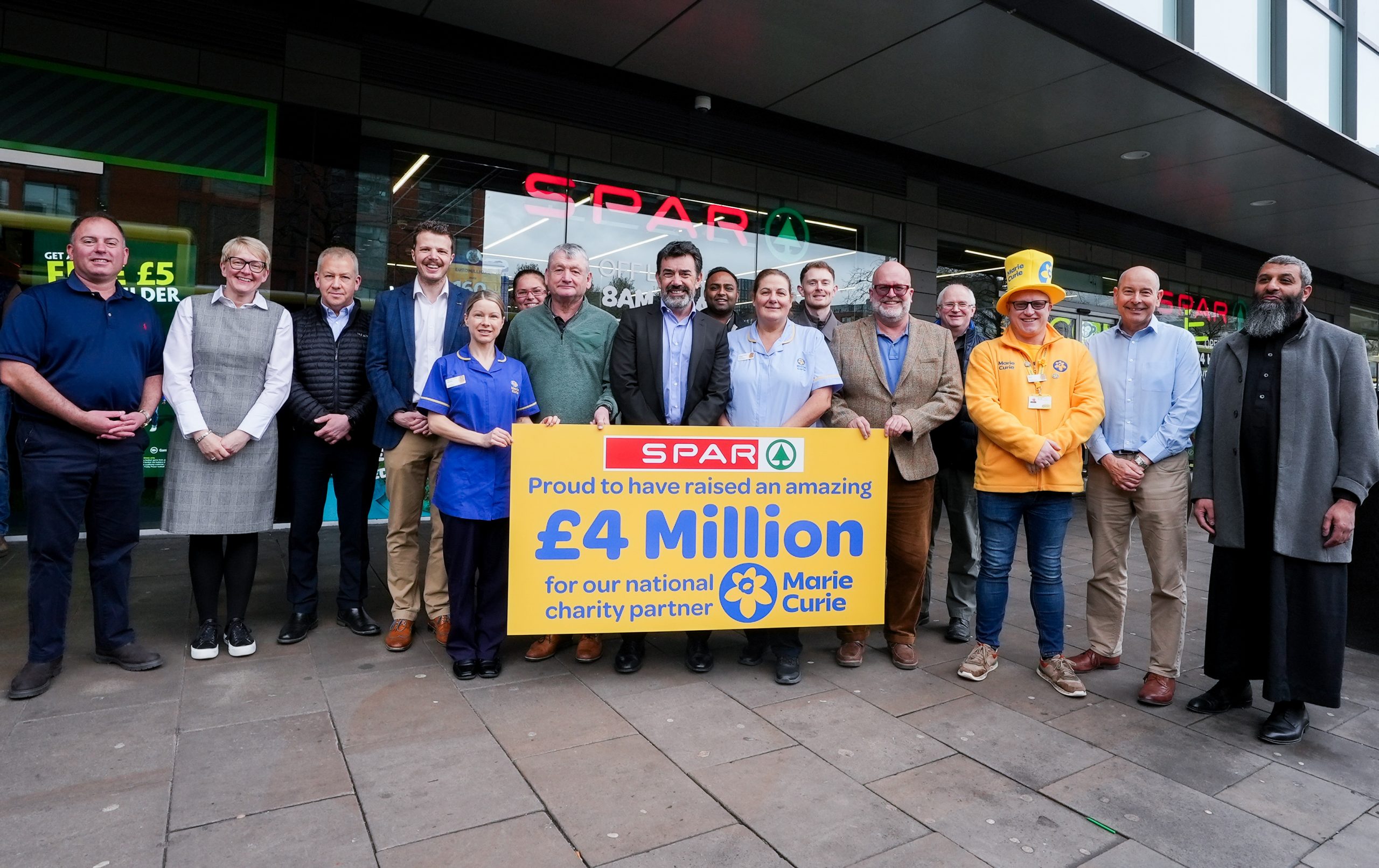 SPAR x Marie Curie £4m 1 Outside SPAR City Tower, Manchester, SPAR retailers join Marie Curie Nurses and their Community Fundraiser to celebrate a remarkable milestone - raising £4 million for Marie Curie to support vital end-of-life care across the UK.