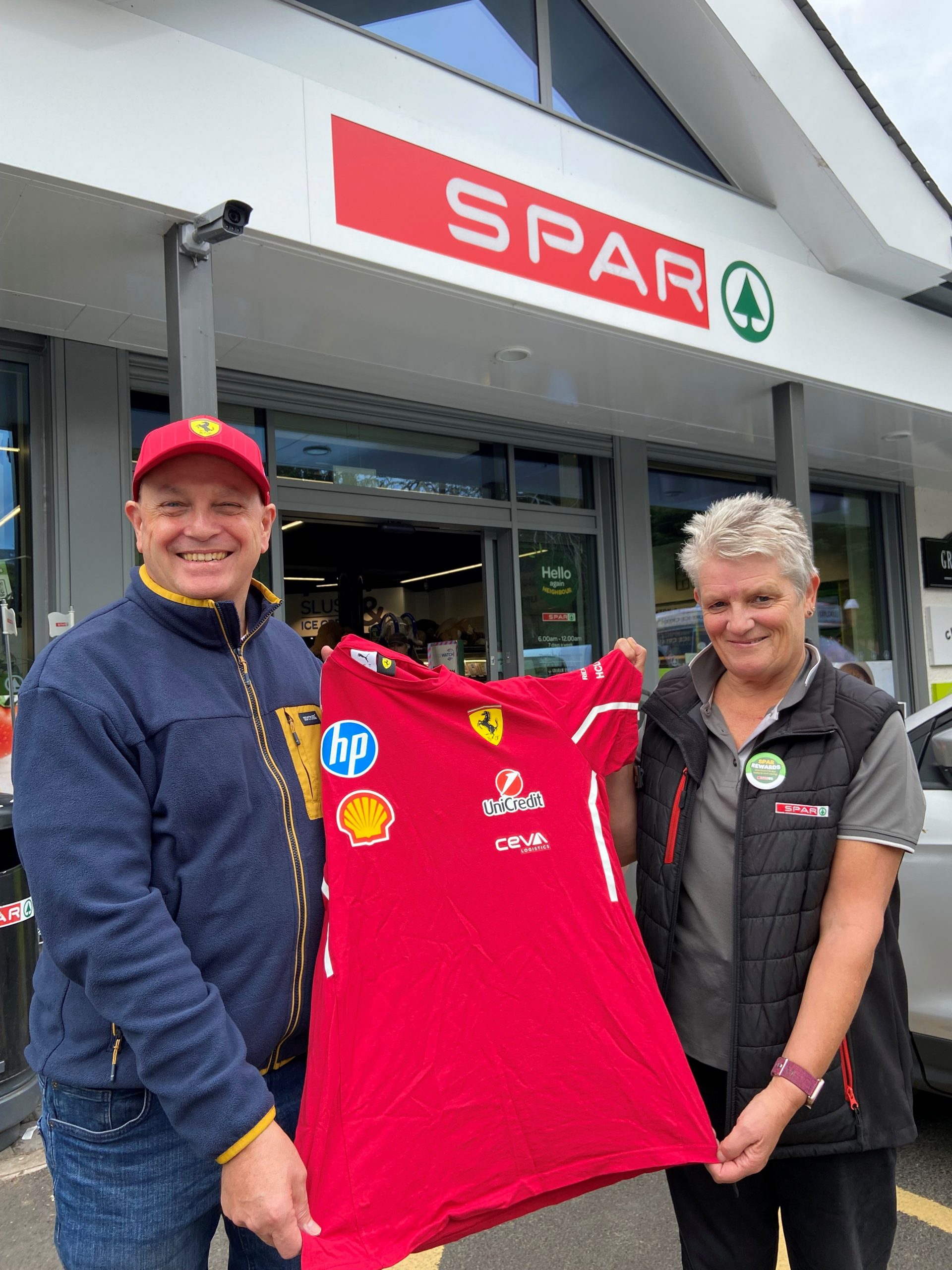 Scuderia Ferrari F1 merchandise winner Simon Rigg with Sharon Morton at SPAR Bowness